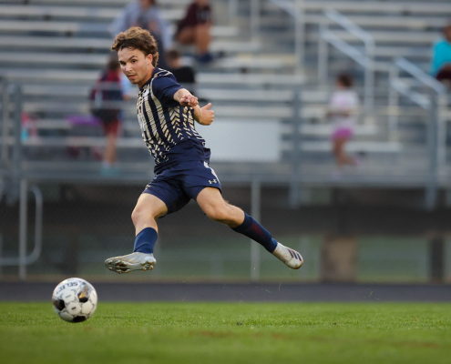 action shot photography action shot photography of boy playing soccer